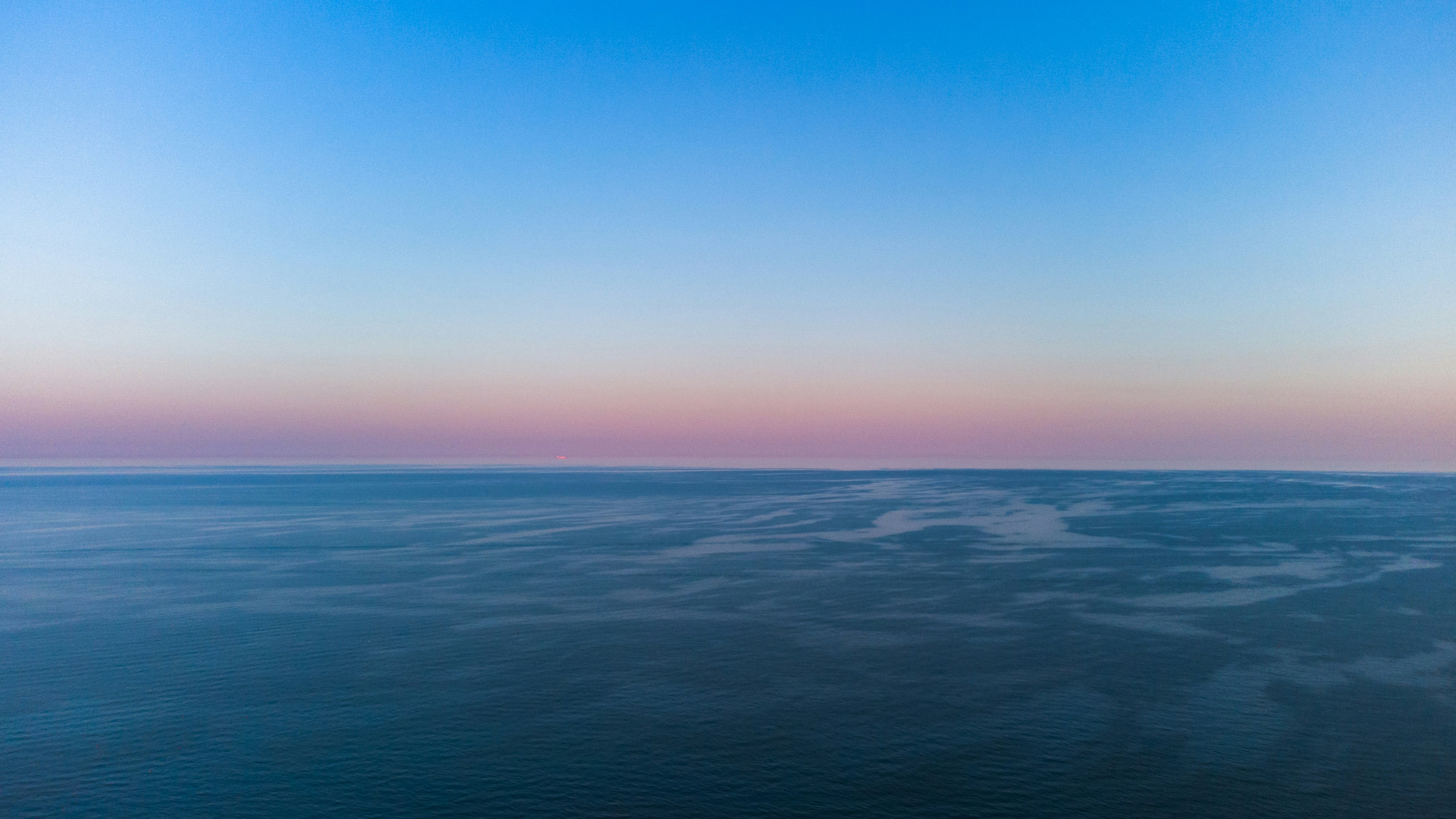 blue ocean water under blue sky during daytime